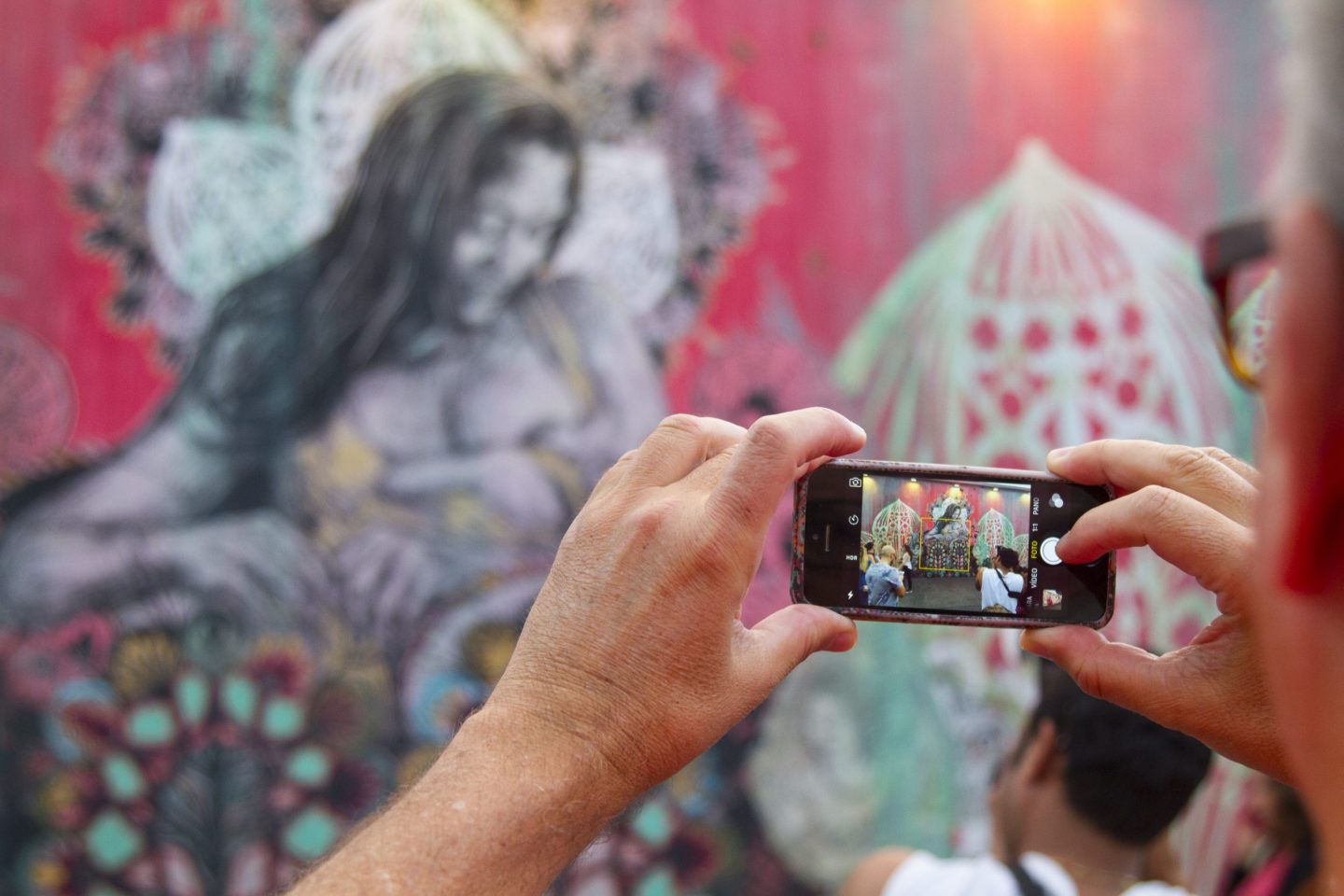 Miami, FL, USA - December 27, 2015: A man taking a digital memory for the Wynwood's art murals on 2520 Northwest 2nd Avenue.
